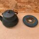 Old green cast iron Japanese teapot with flower decoration + vintage stand