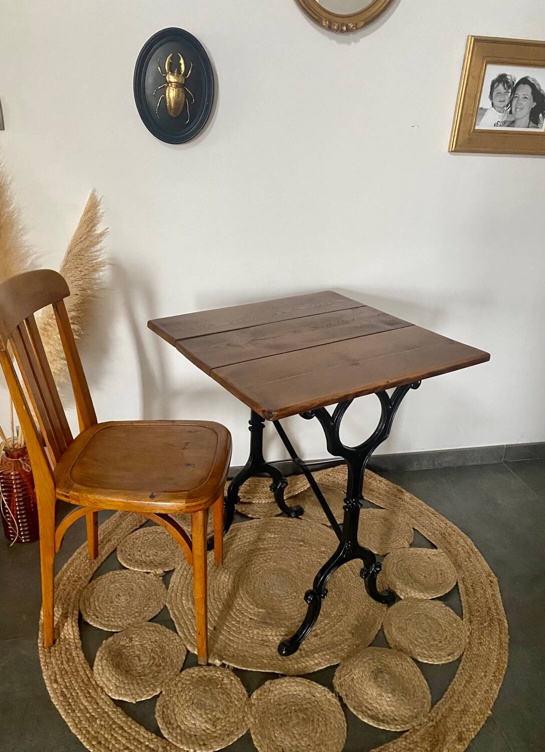 Bistro table with iron legs and raw wood top.