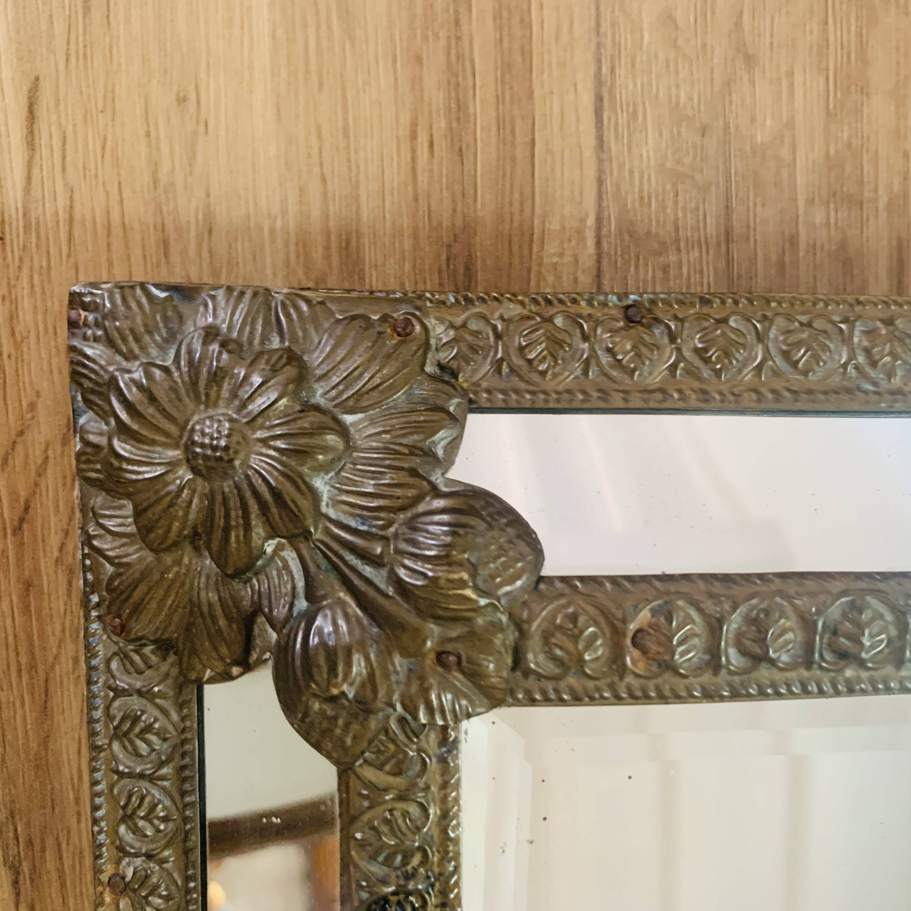Small mirror with repoussé brass frame.