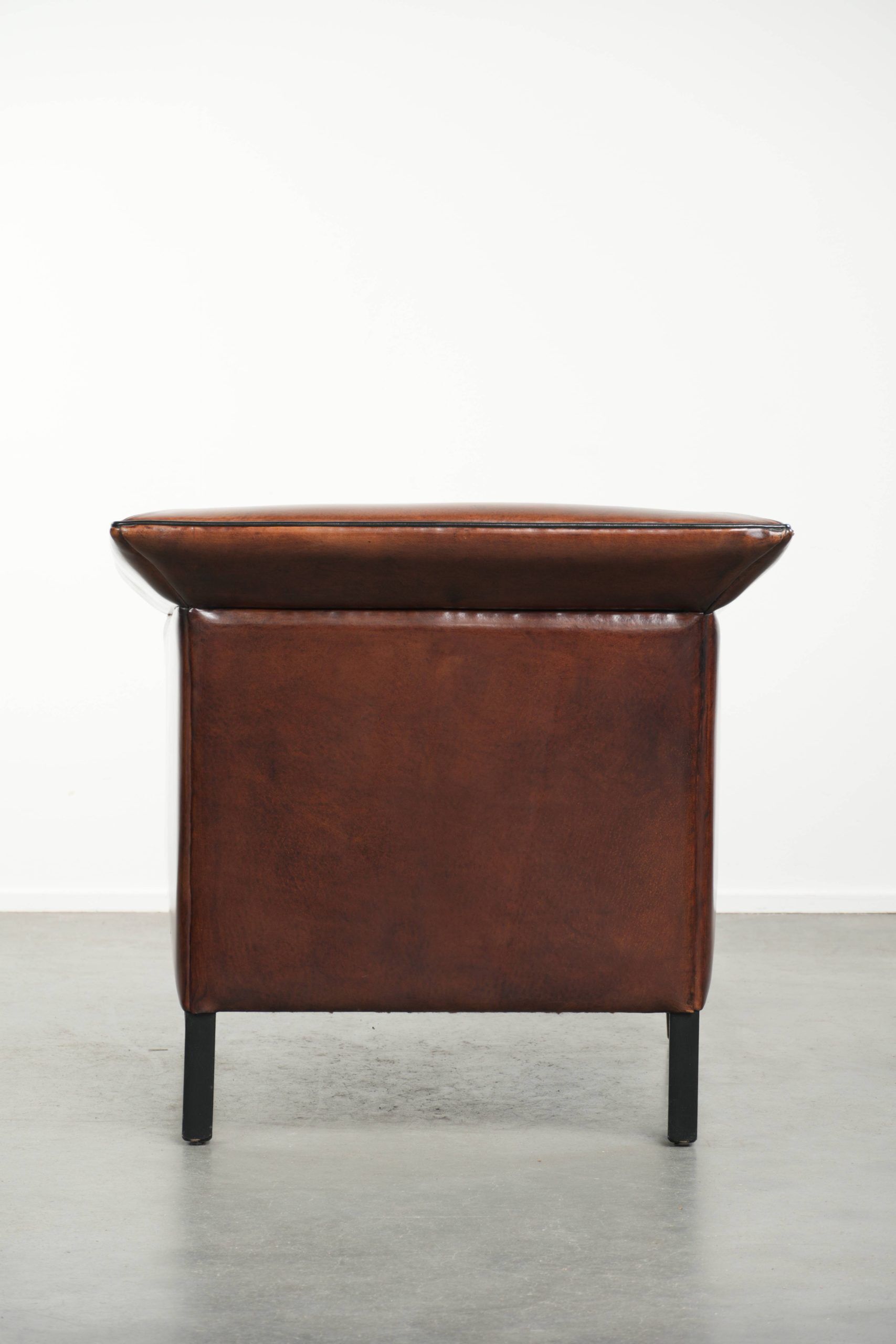 Sleek sheepskin Art Deco design armchair with black piping