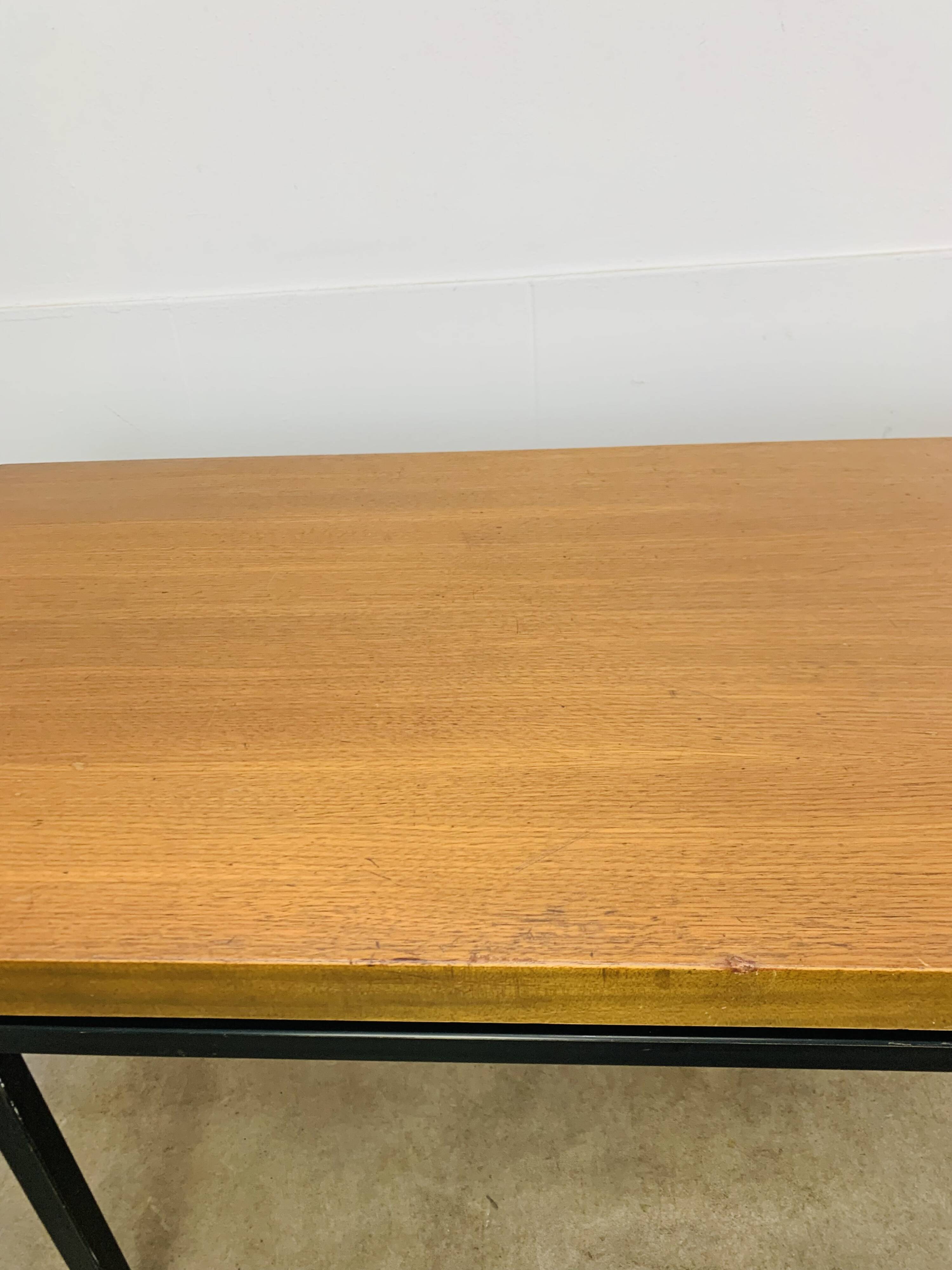 1950s modernist coffee table, wood and black metal.