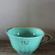 Green and gold cup from the Moi Salins collection.