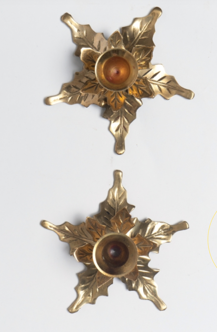 Two candlesticks in holly leaves