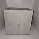 Square planter with a patinated iron lion's head