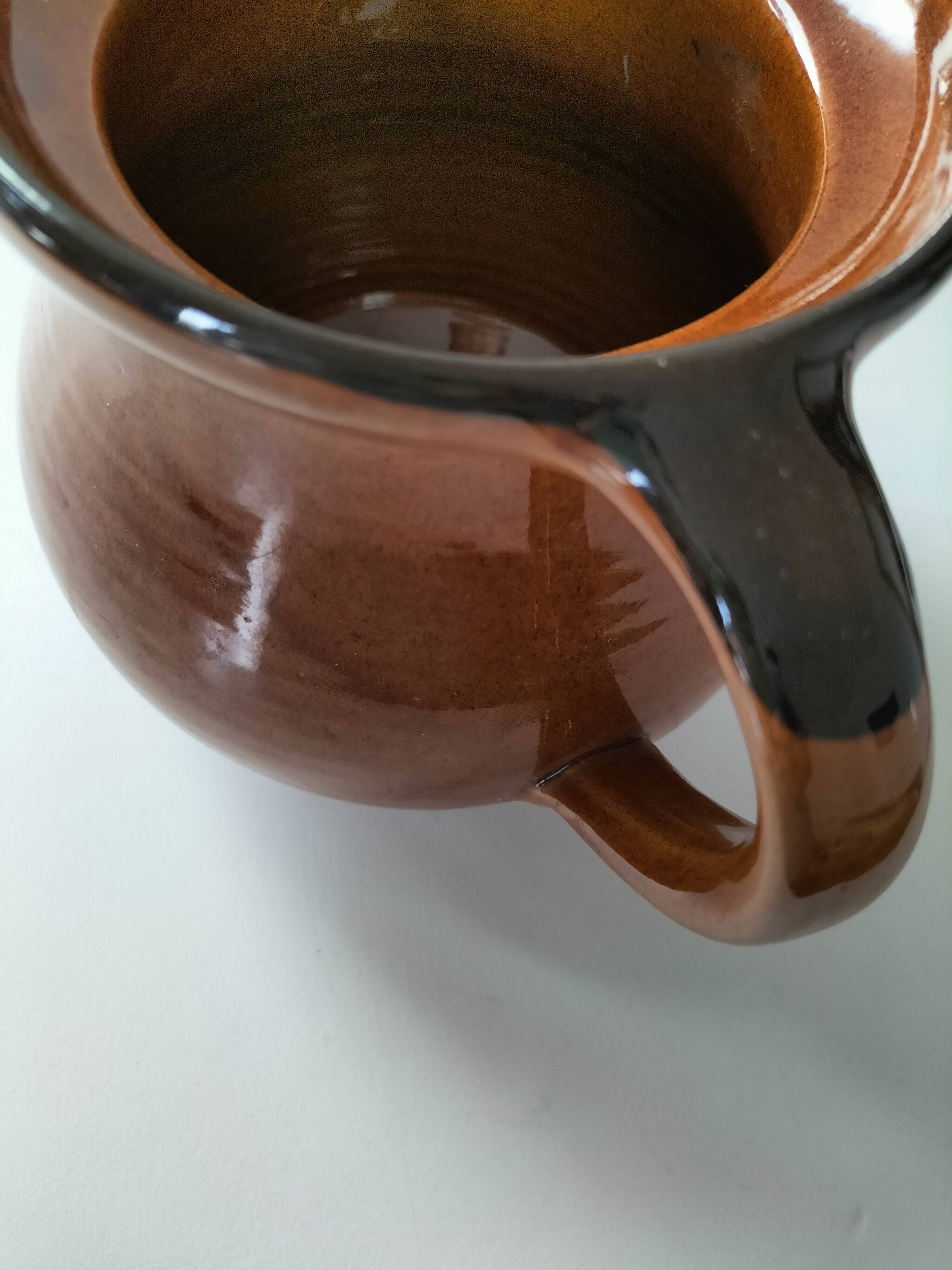 Glazed earthenware pitcher signed HR with a design of stylised birds.