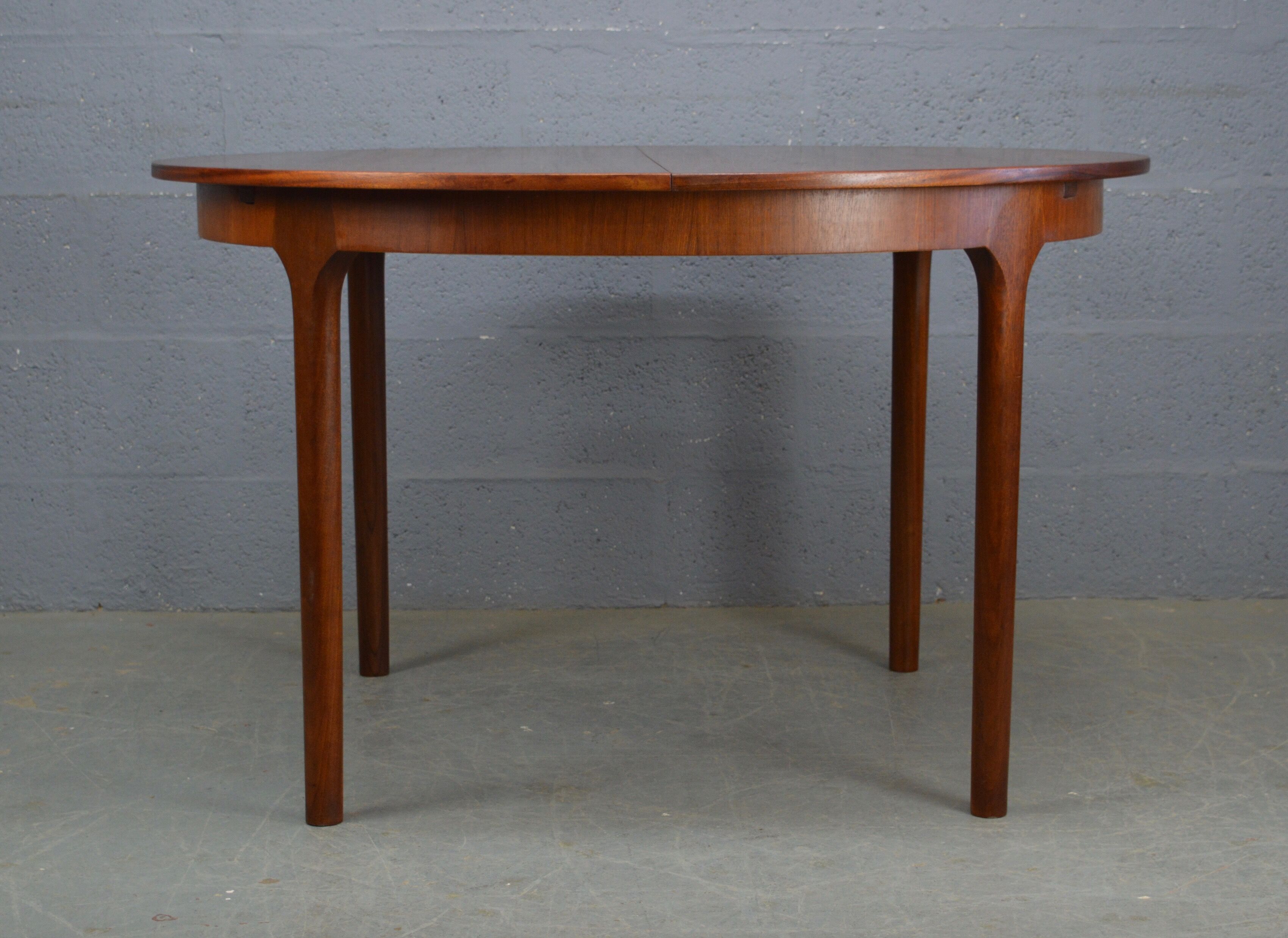 Round teak dinning table and chairs by Mctintosh