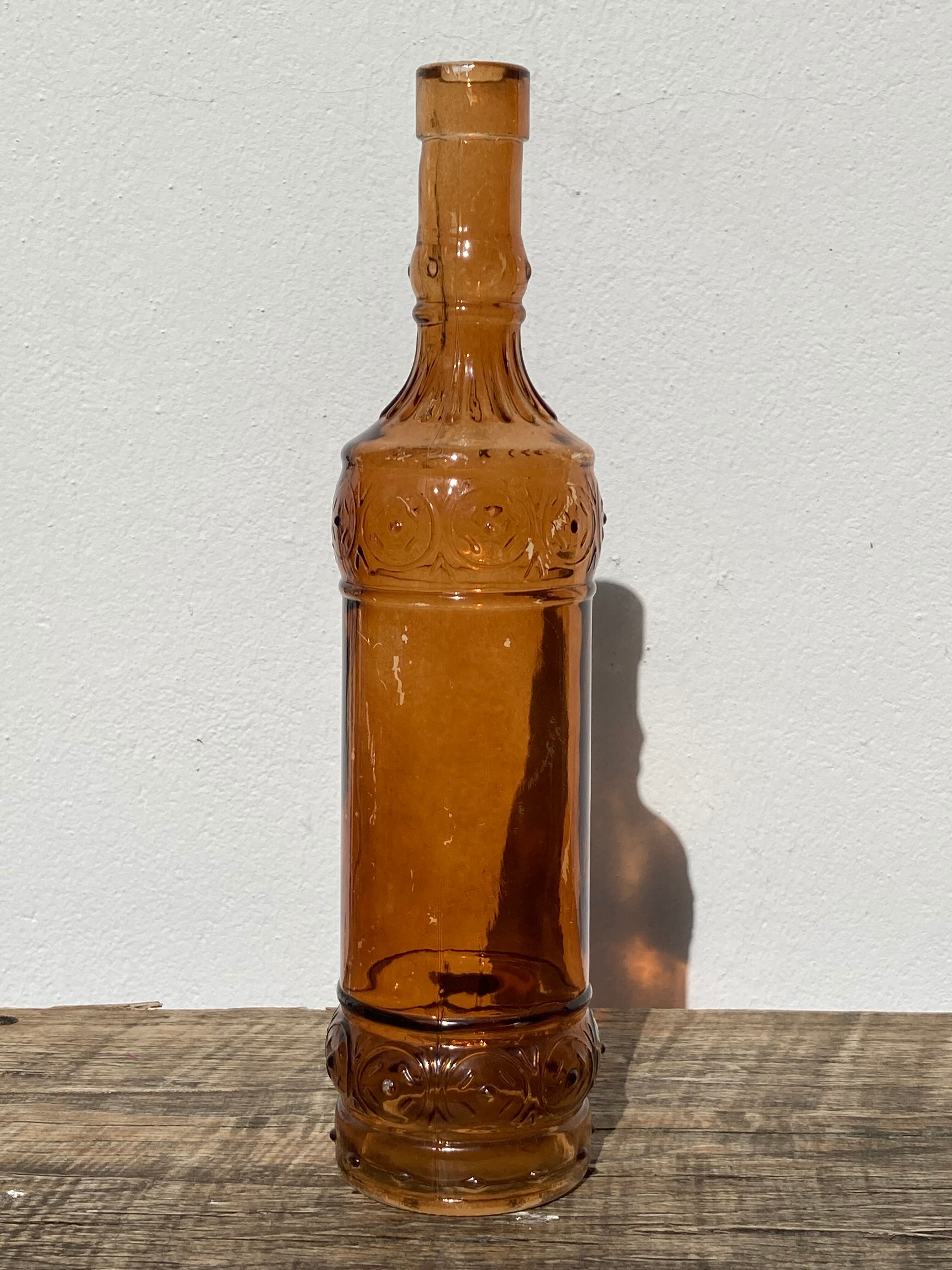 Vintage amber bottle in patterned brown glass