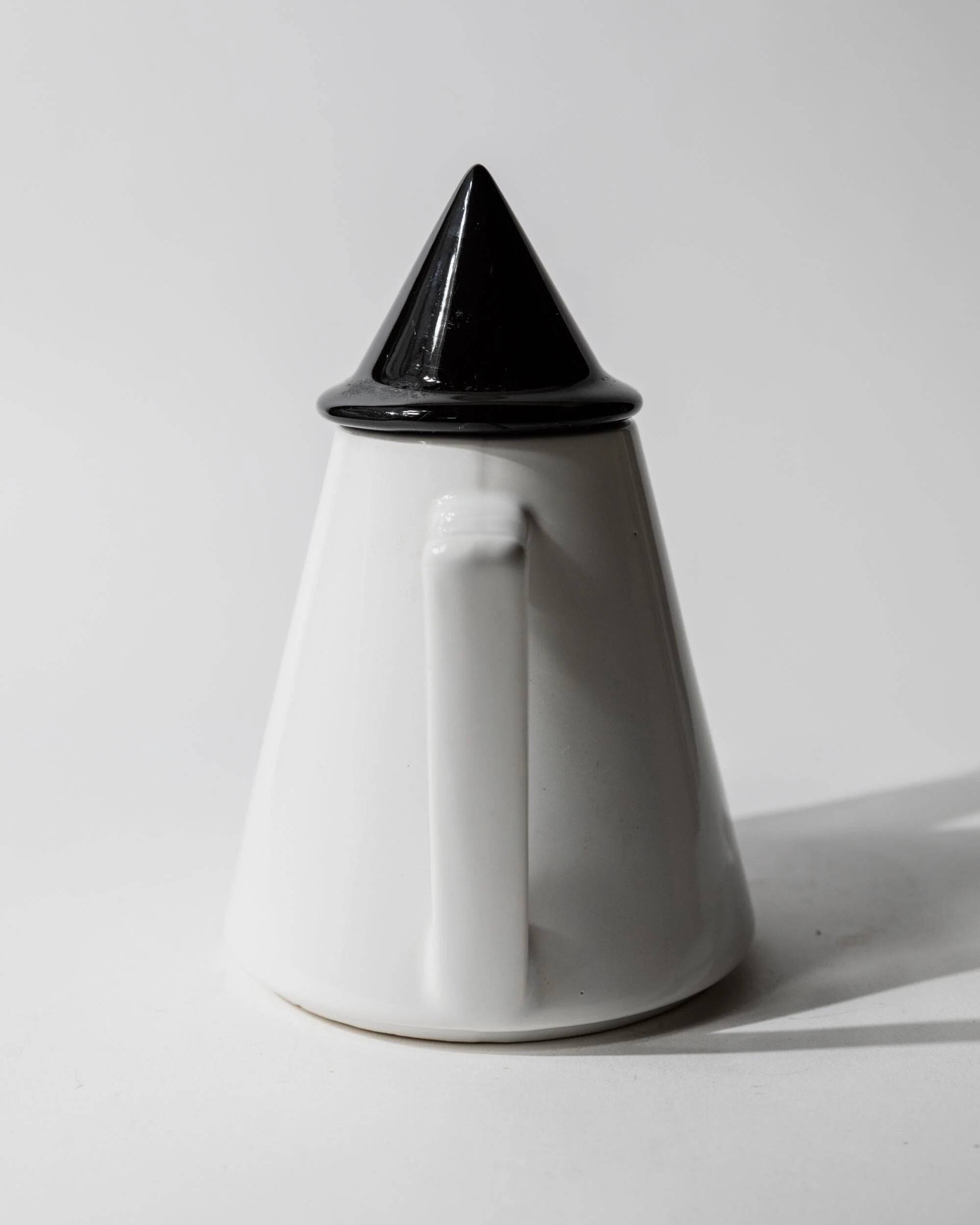 Vintage ceramic coffee pot or teapot from the 1980s, postmodern Memphis design, black and white triangles.