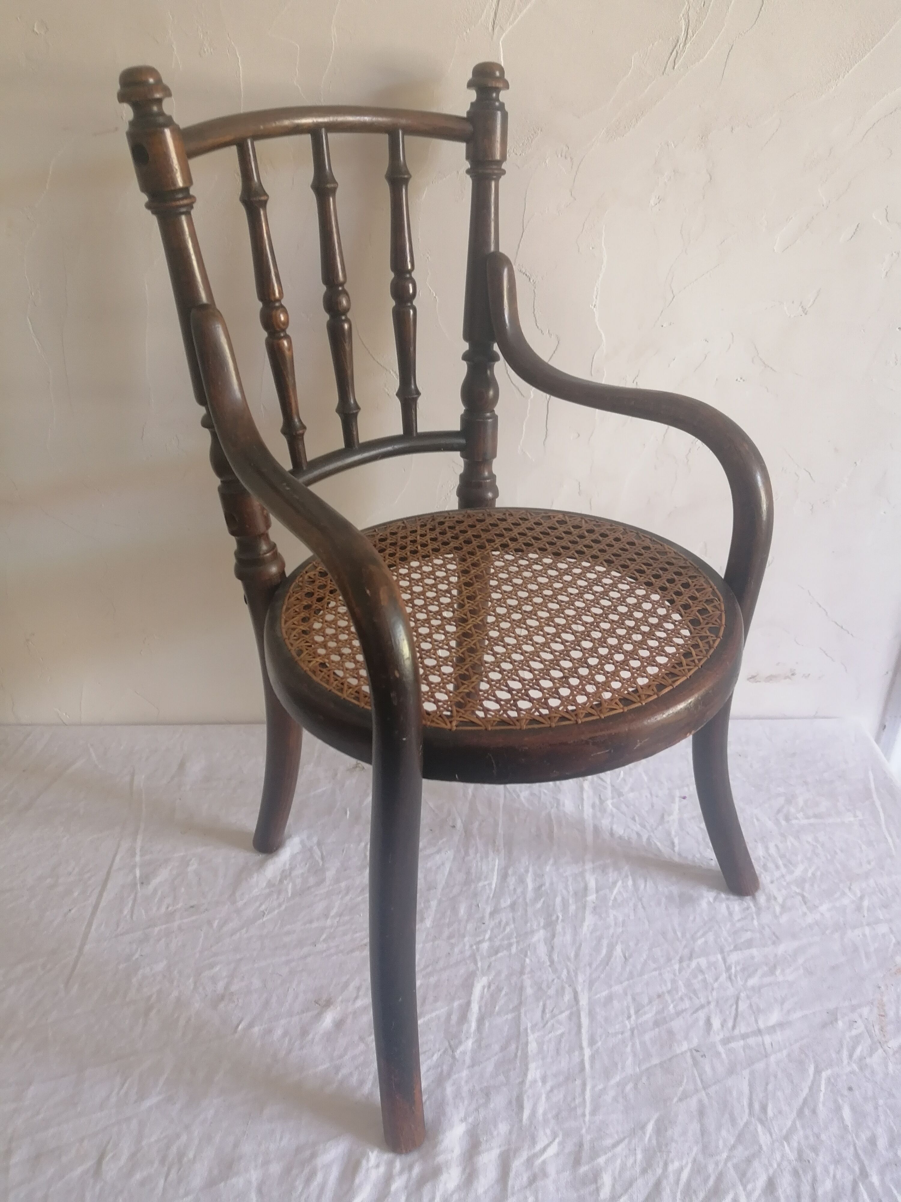 Old children's armchair in curved wood. Fischel