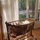 Wooden cradle in walnut with a sign collar at the top.