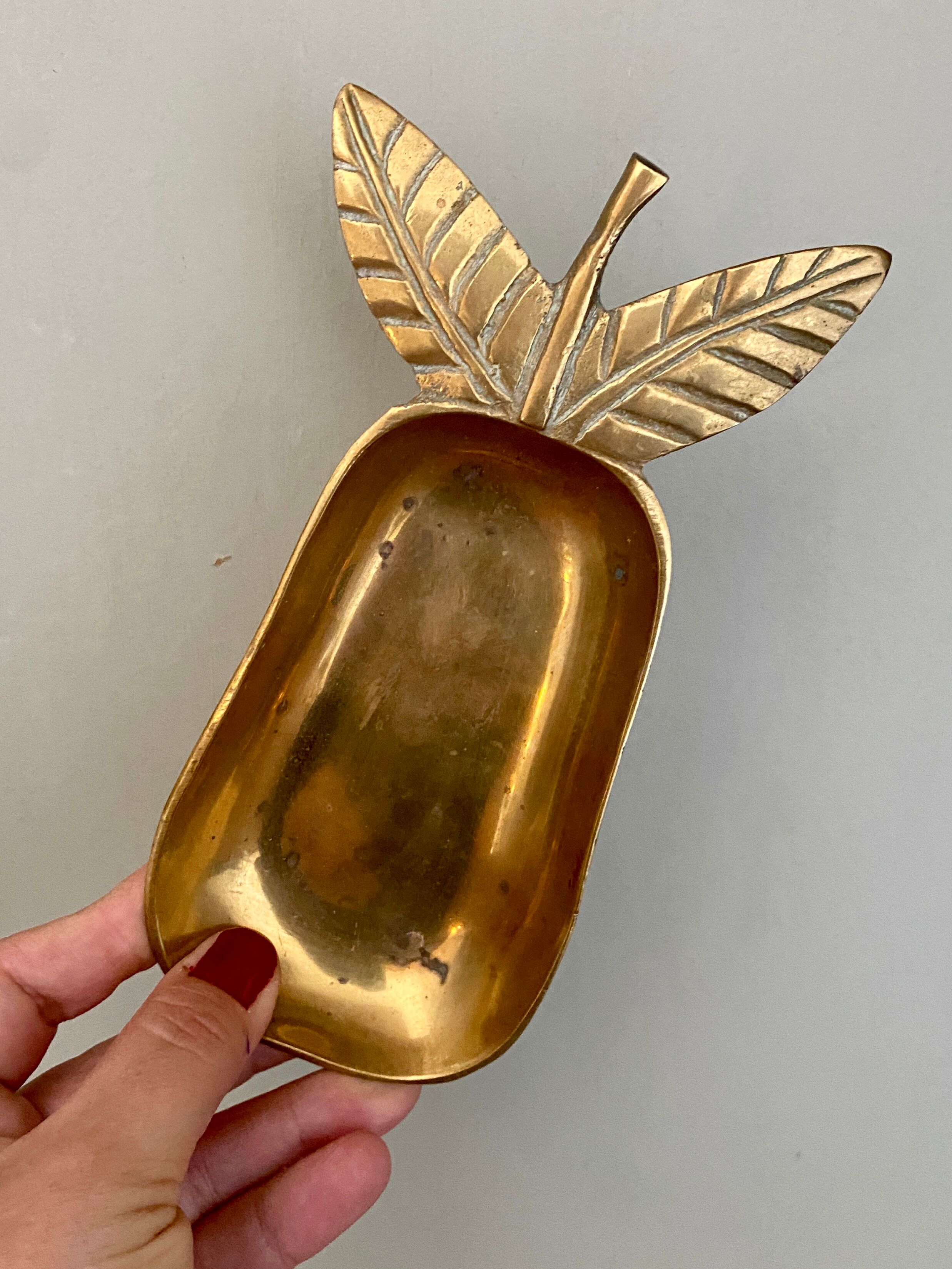 Empty vintage pear-shaped brass pocket