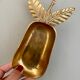 Empty vintage pear-shaped brass pocket