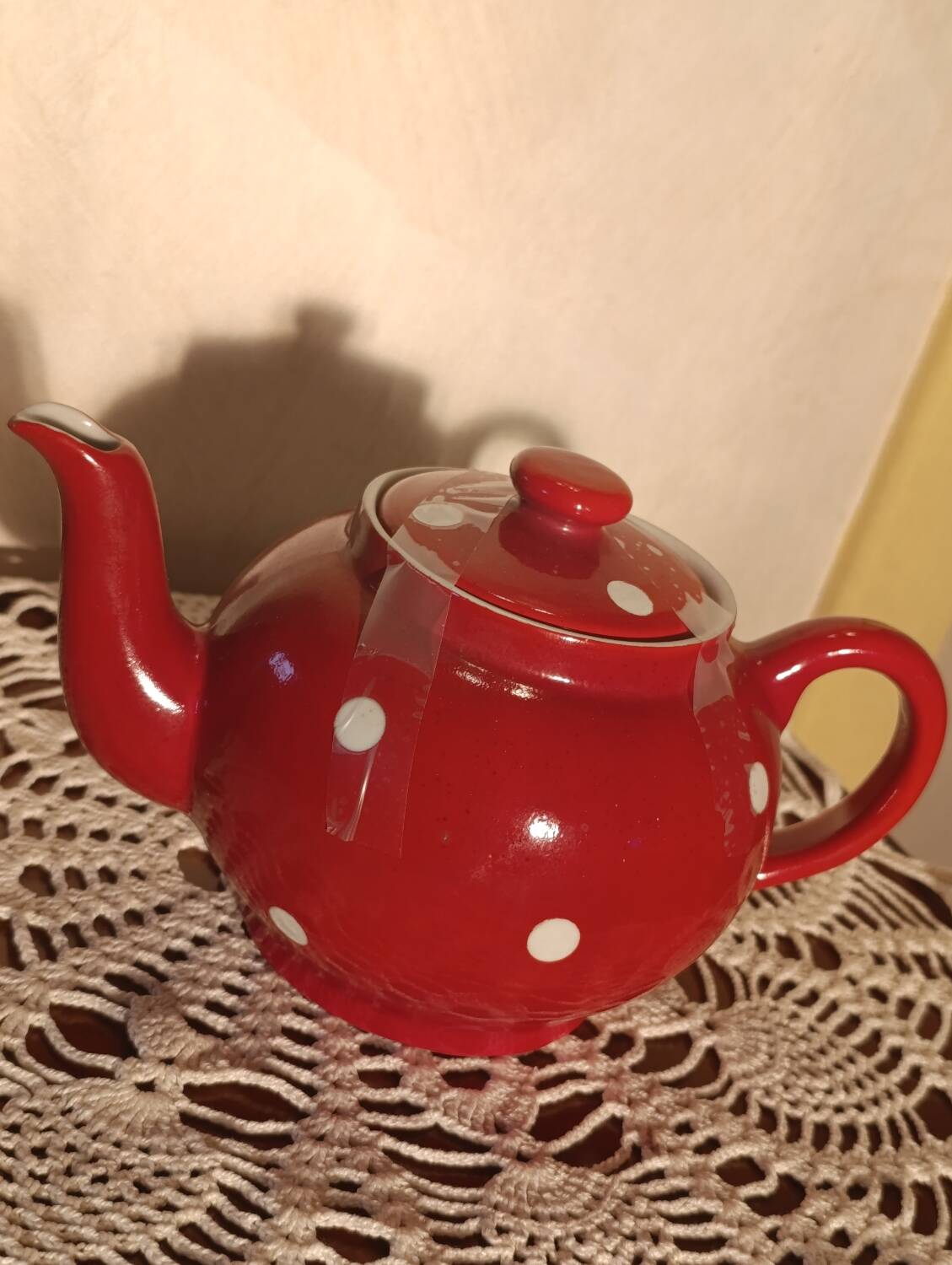 Vintage red teapot with white polka dots.