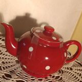 Vintage red teapot with white polka dots.