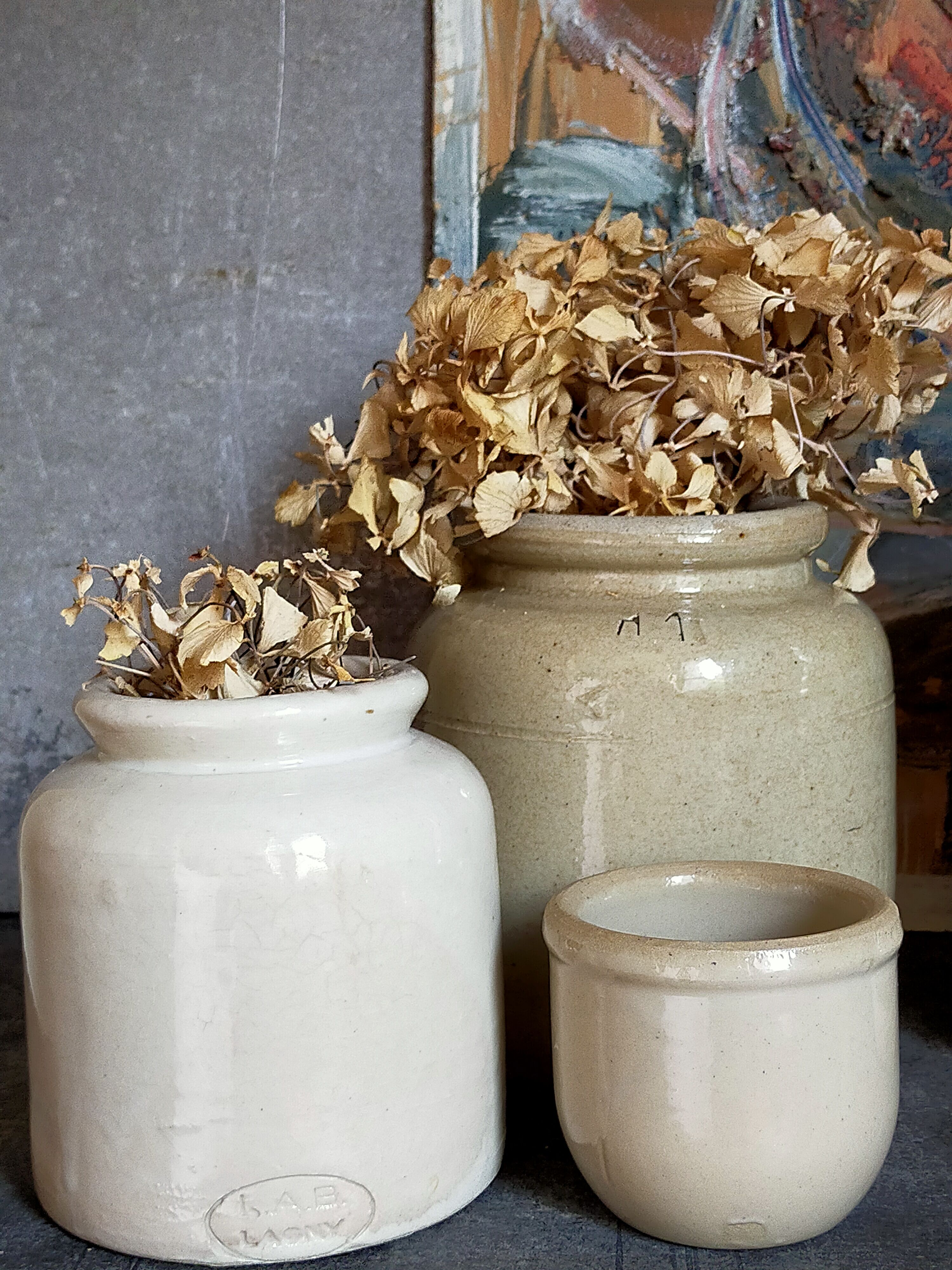 Set of three pots with old condiments in glazed earth