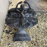 Cast iron vase decorated with mermaids.