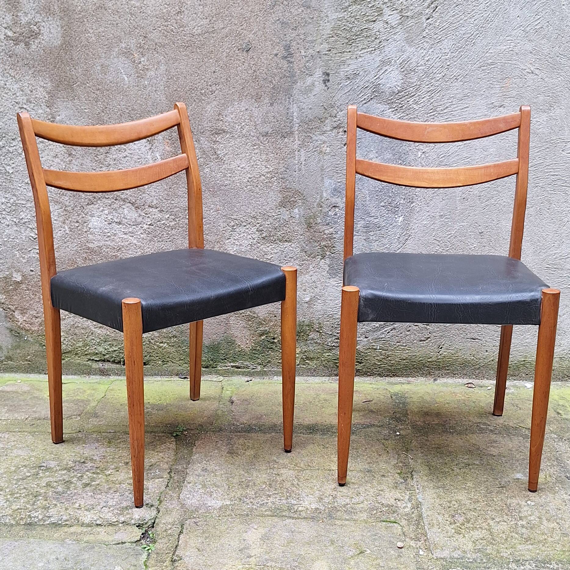 Pair of Scandinavian style chairs in wood and faux leather.