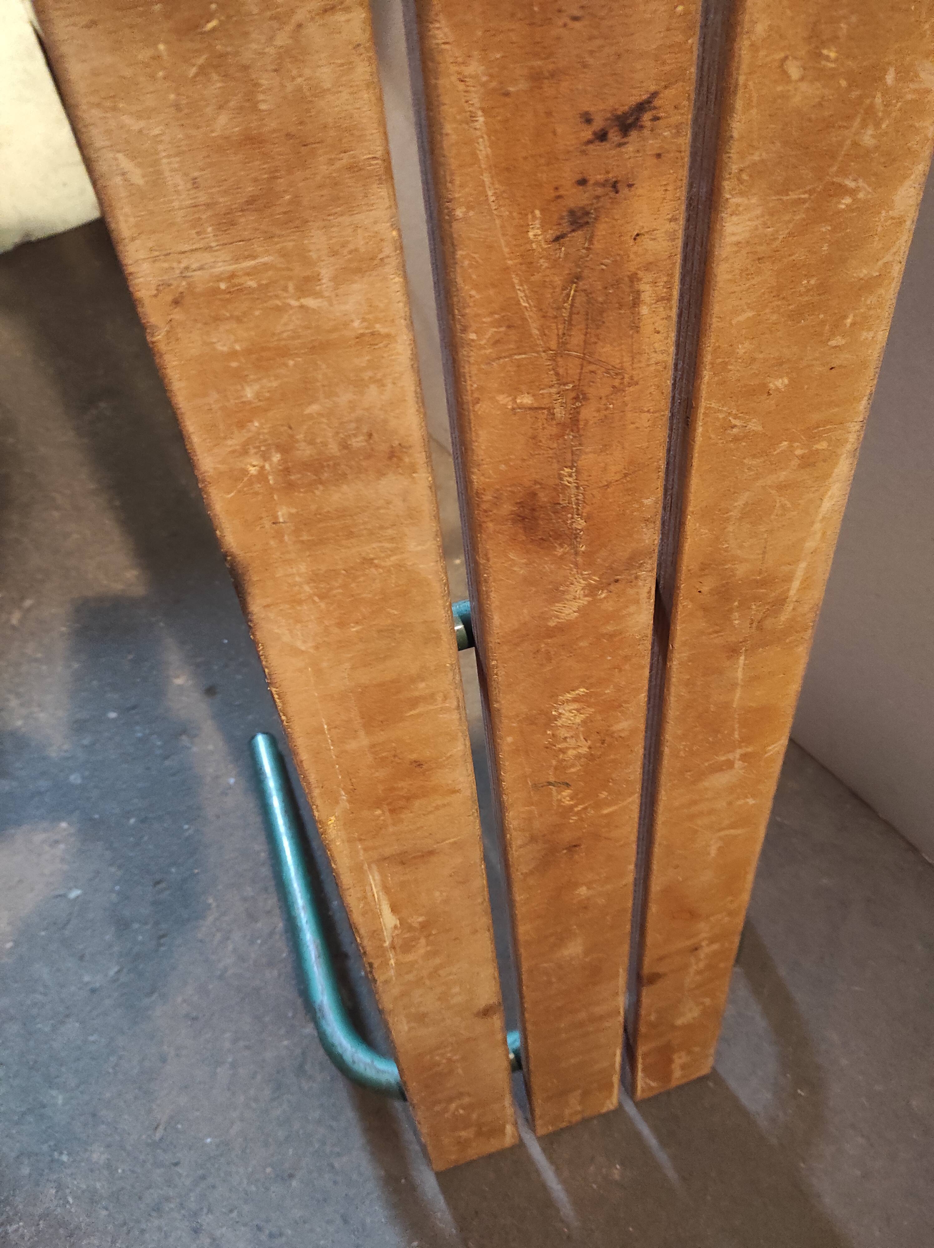 Former vintage wooden school bench and metal tubes