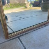 Mirror between two in gilded wood