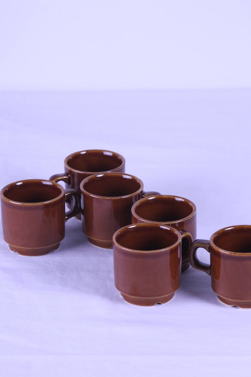 6 brown stackable coffee cups
