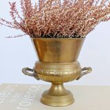 Vintage brass cache-pot on a stand with handles, classic decor.
