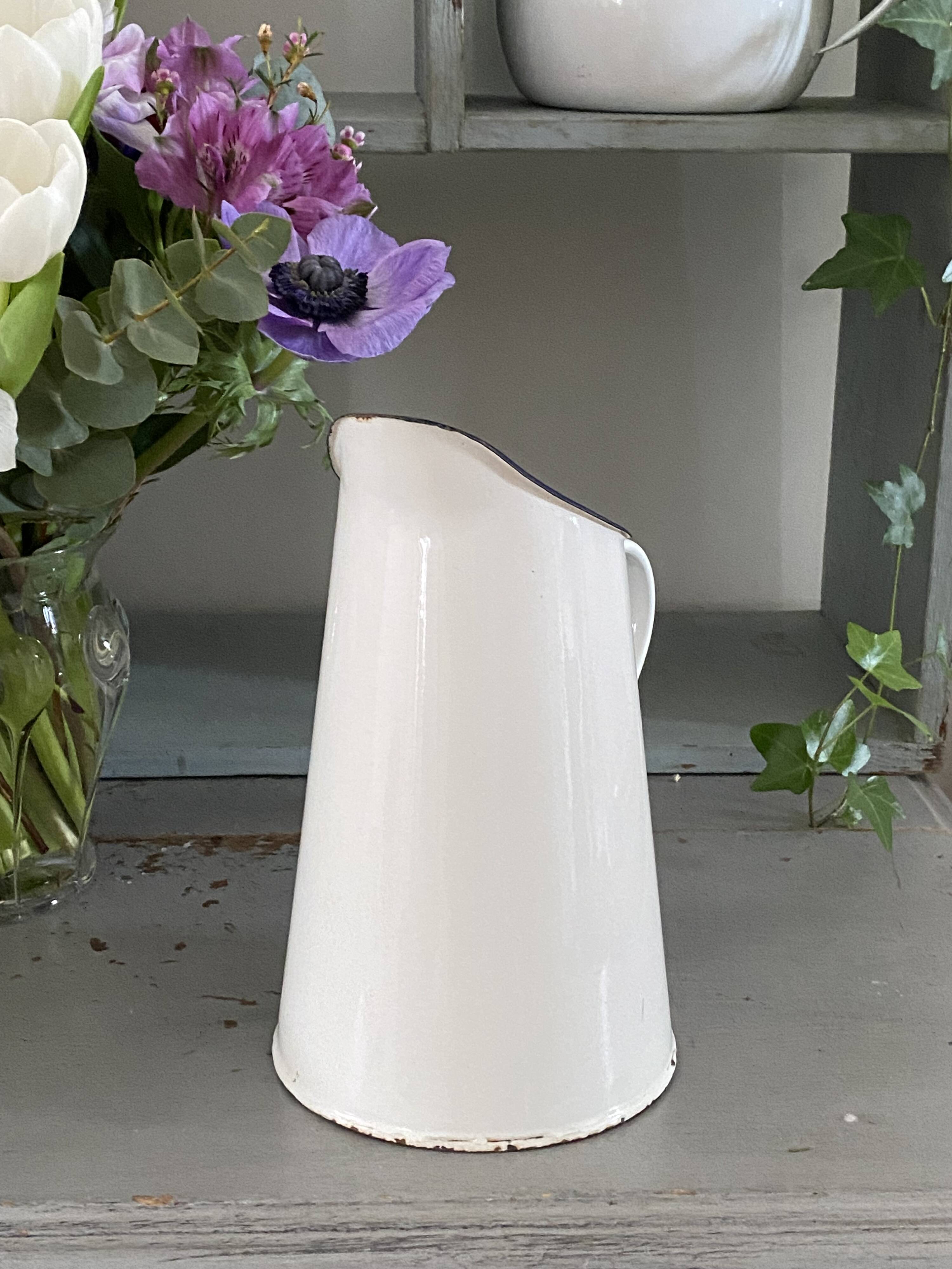 Old white enameled pitcher