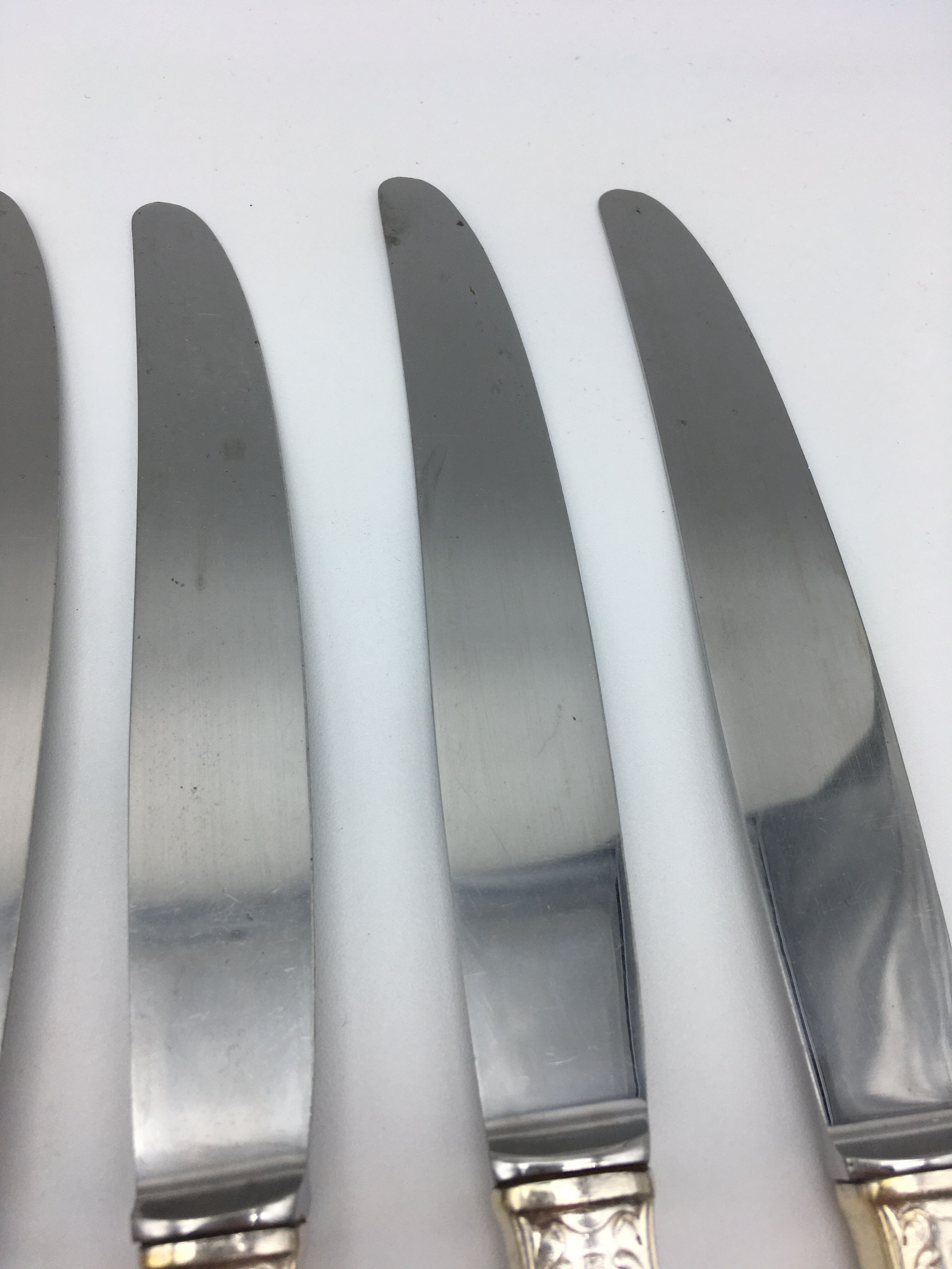 12 silver metal knives.