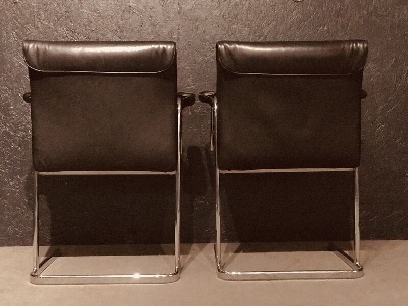 Pair of black leather Scandinavian armchairs