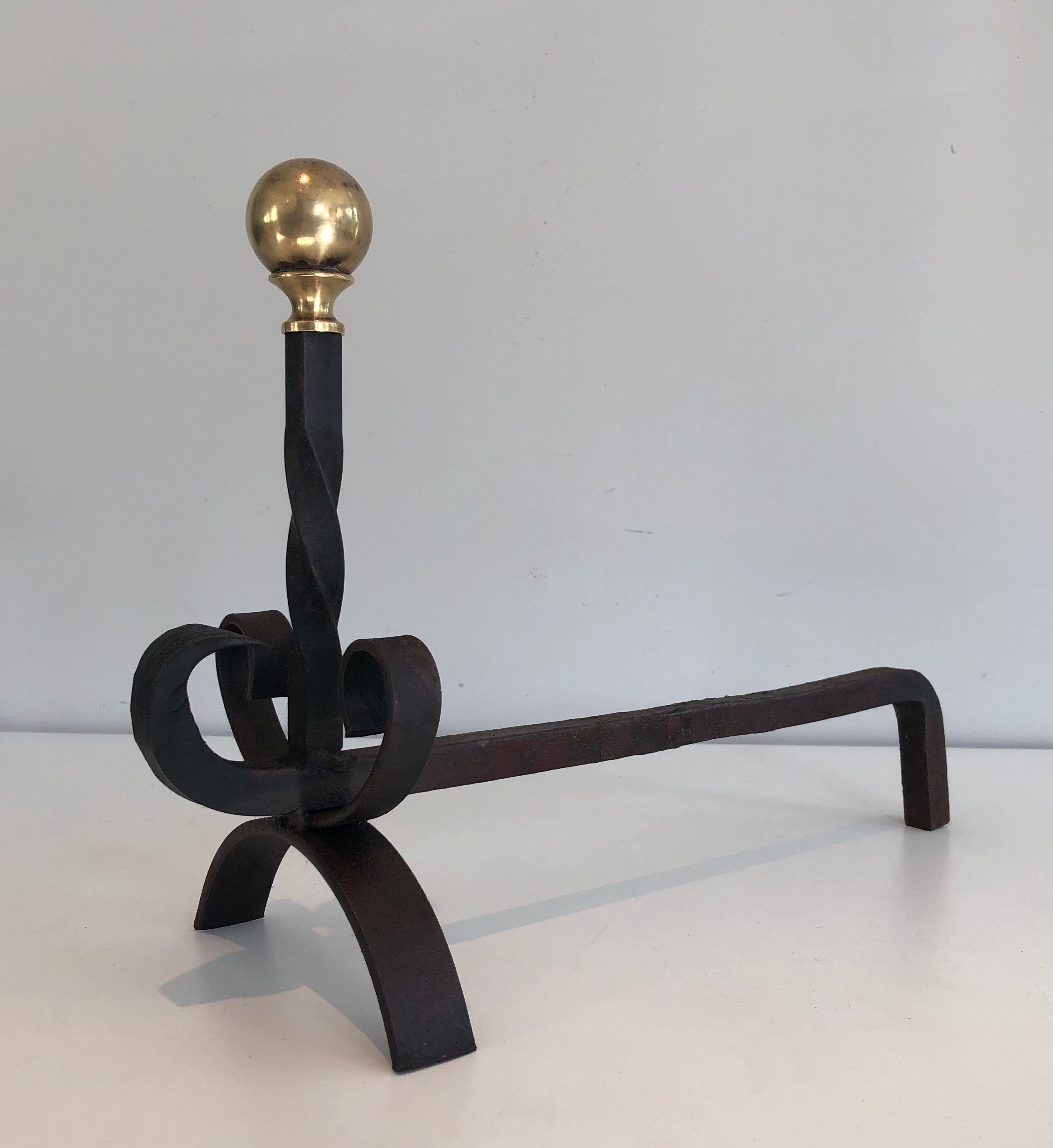Paire de chenets en fer forgé et laiton. travail français. vers 1950