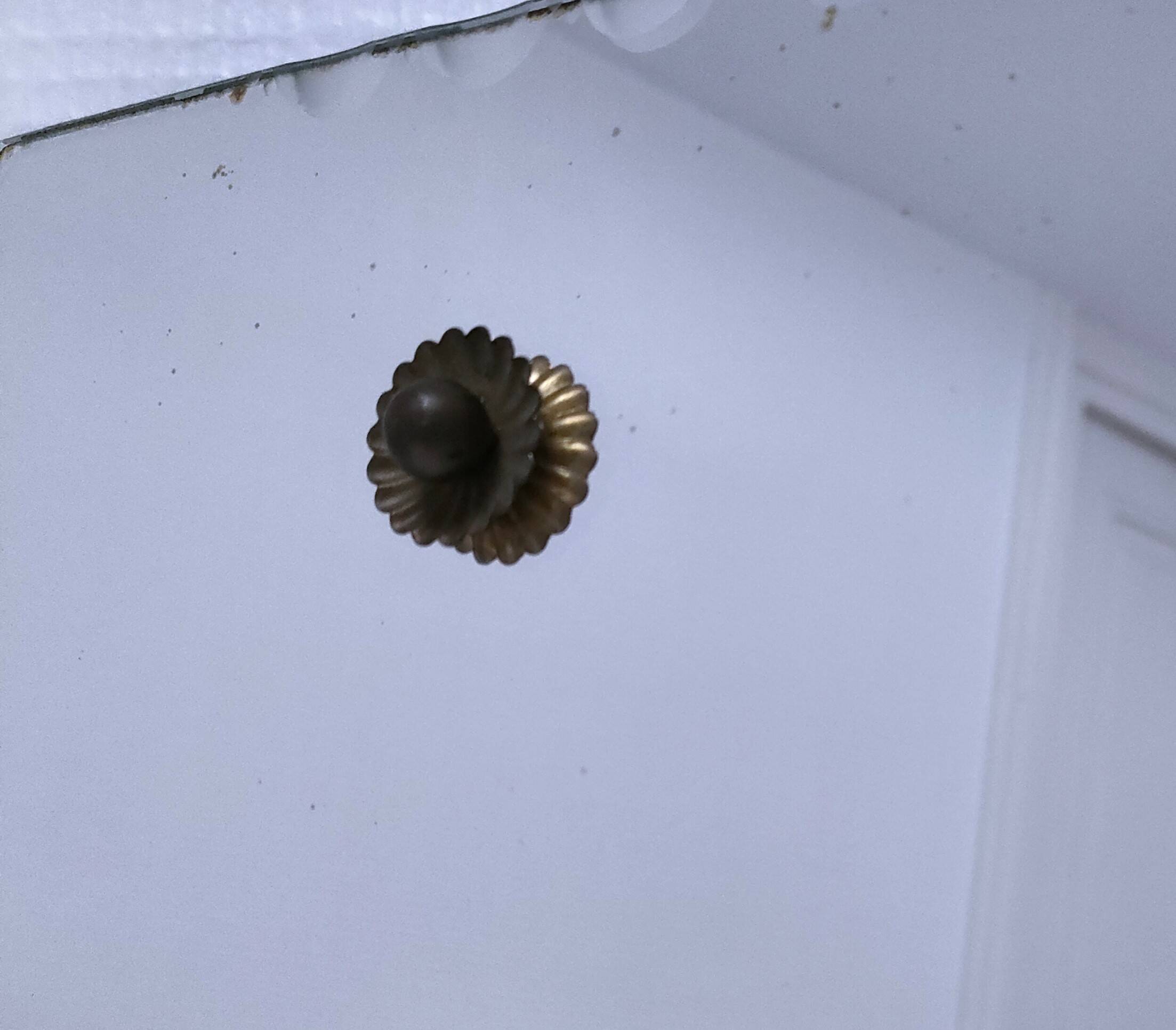 Octagonal mirror with brass hubcaps from the 60s