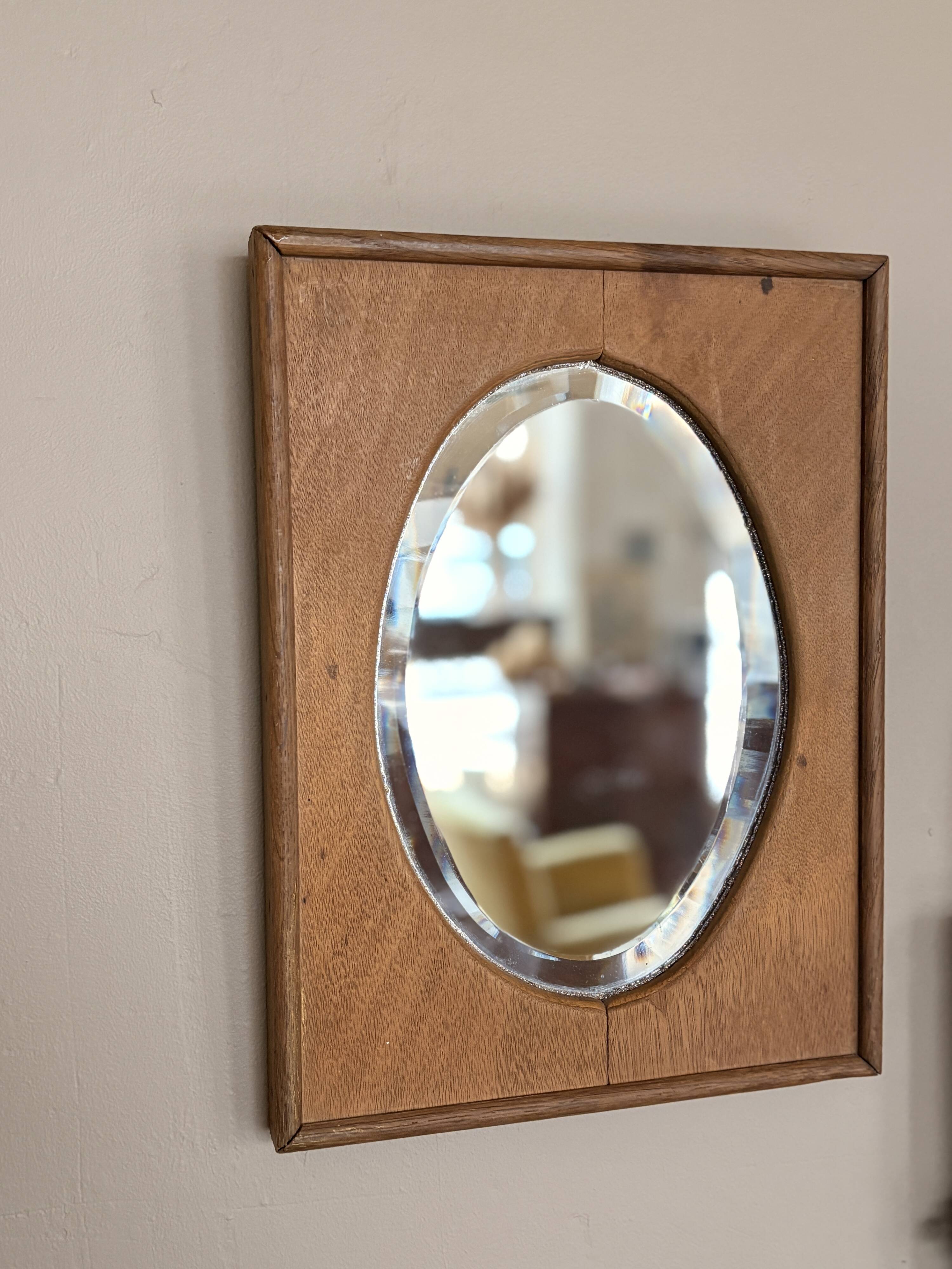 Bevelled oval mirror on oak frame