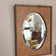 Bevelled oval mirror on oak frame