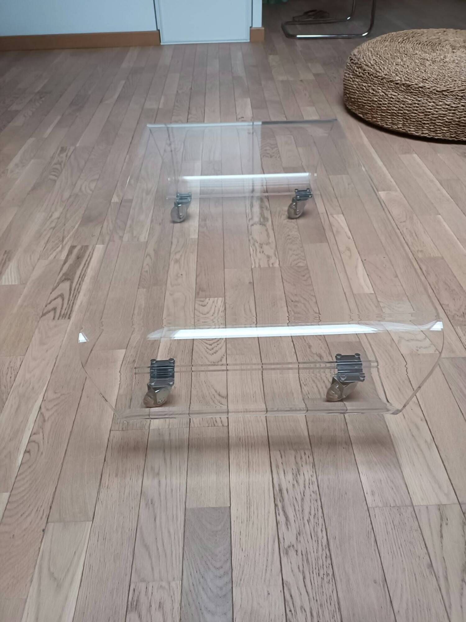 Design coffee table from Habitat in transparent plexiglass, mounted on wheels.