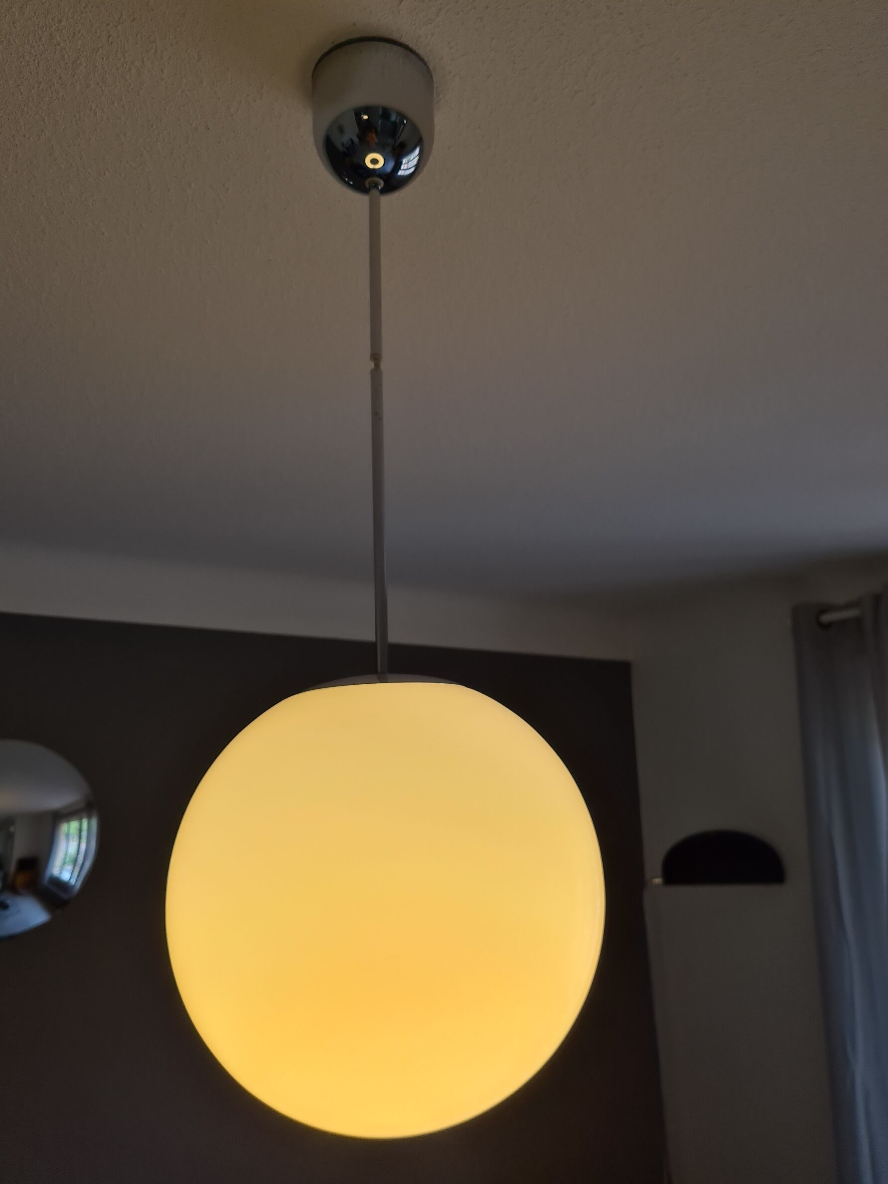 Suspended light white glass globe