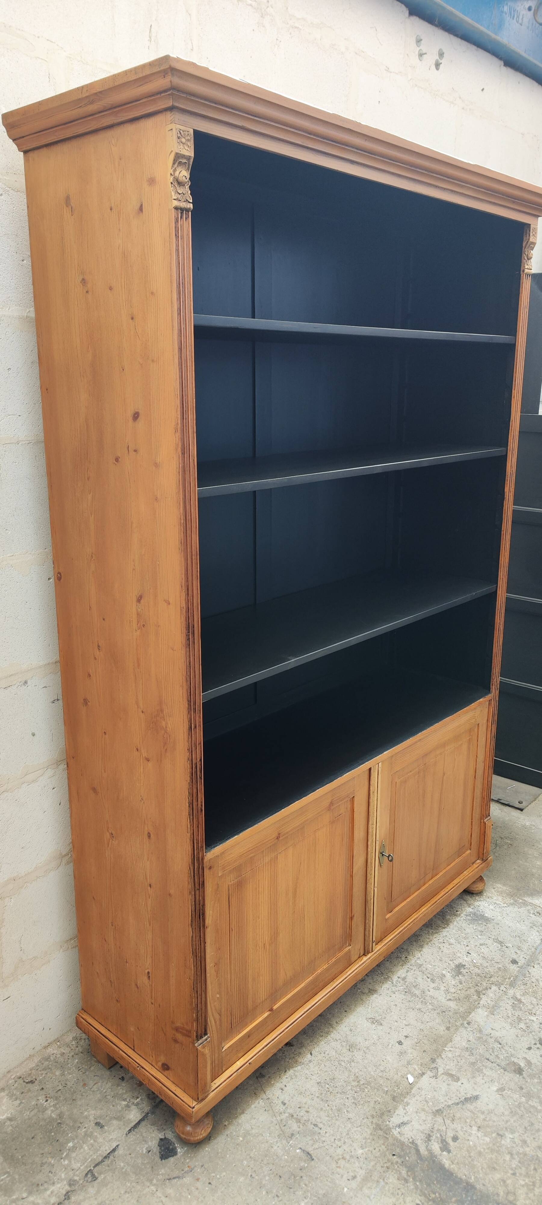 Large waxed pine bookcase with two doors