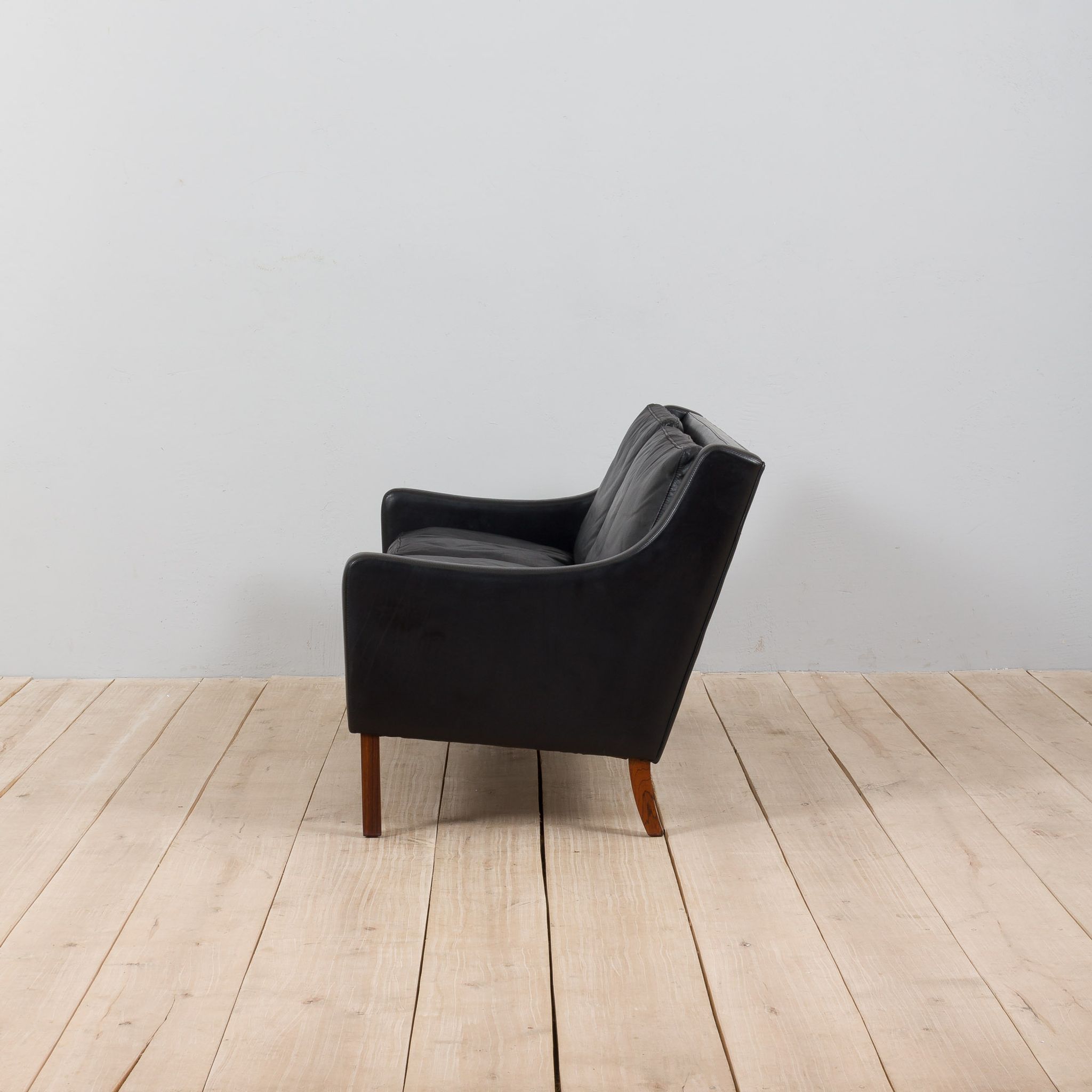 Danish black leather and rosewood sofa