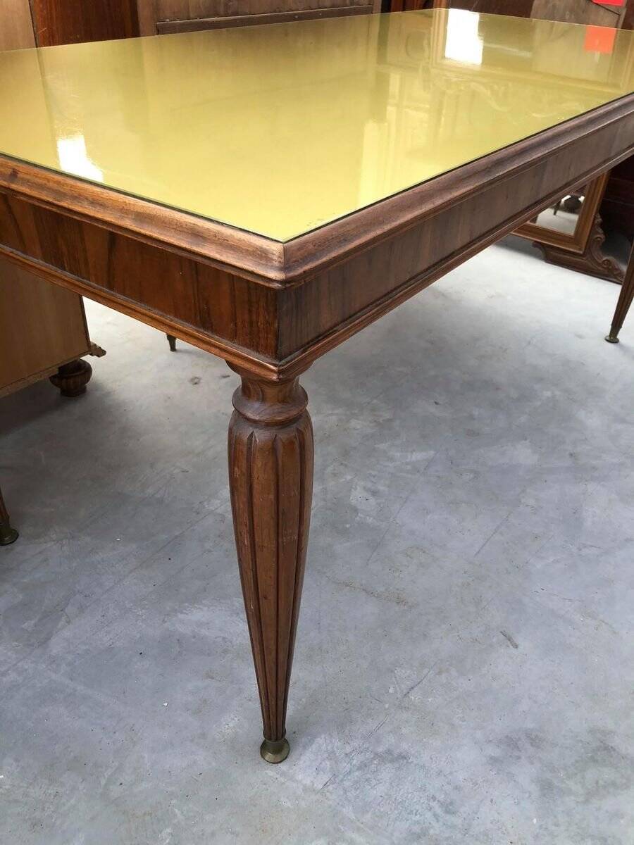 Dining table in the style of Paolo Buffa, made of brown wood with a tinted glass top.