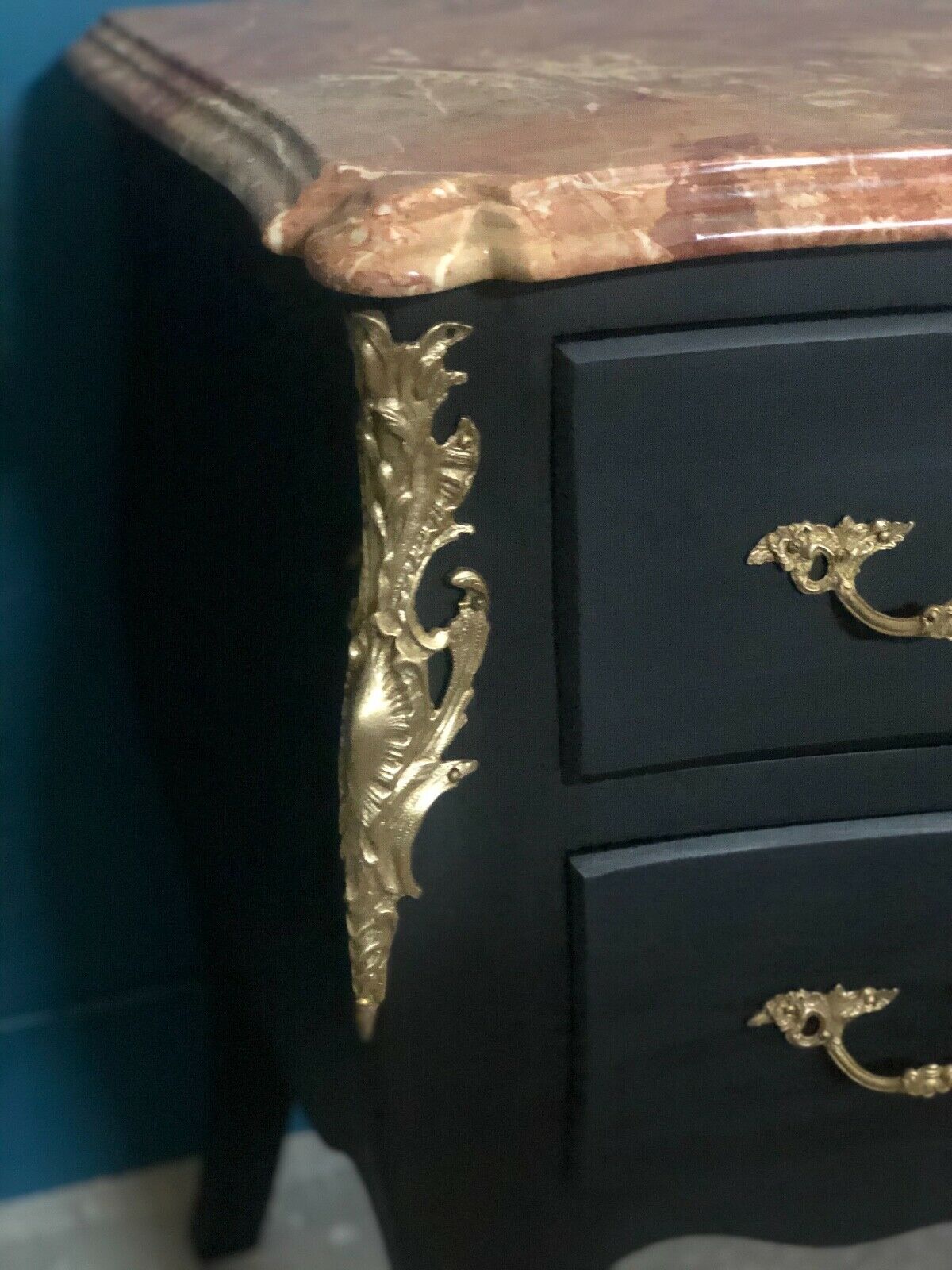 Louis XV style curved black matte commode with gilded bronze ornamentation from the 1950s.