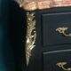 Louis XV style curved black matte commode with gilded bronze ornamentation from the 1950s.