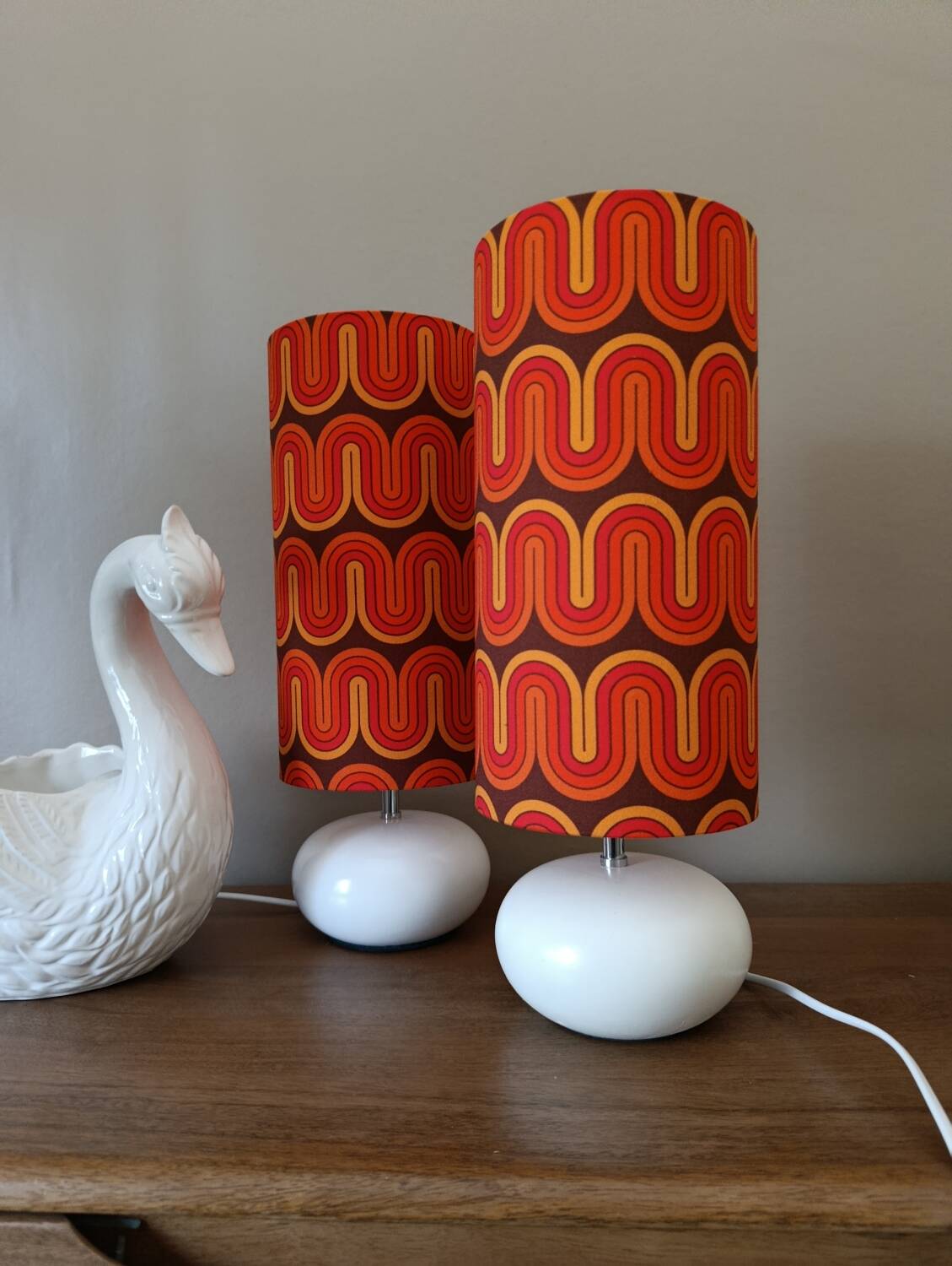Two lamps with a seventies psychedelic wave print.