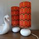 Two lamps with a seventies psychedelic wave print.