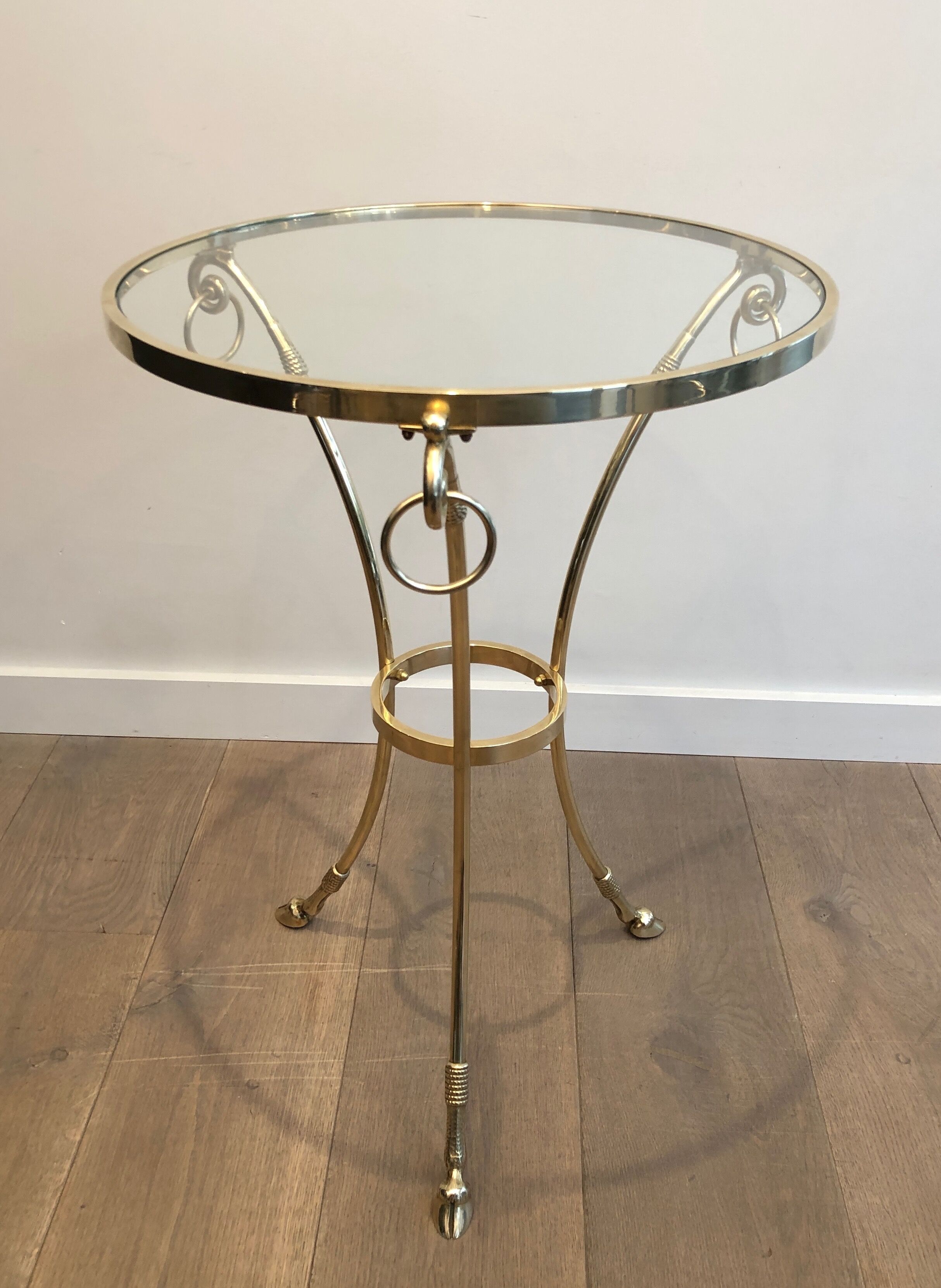 Neoclassical style tripod pedestal table in brass and round glass top in the taste of the House