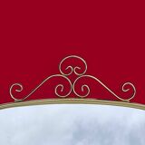 Antique free-form wall mirror with gilt frame and brass ornament