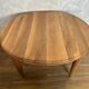 Round dining table with fluted legs in solid wood