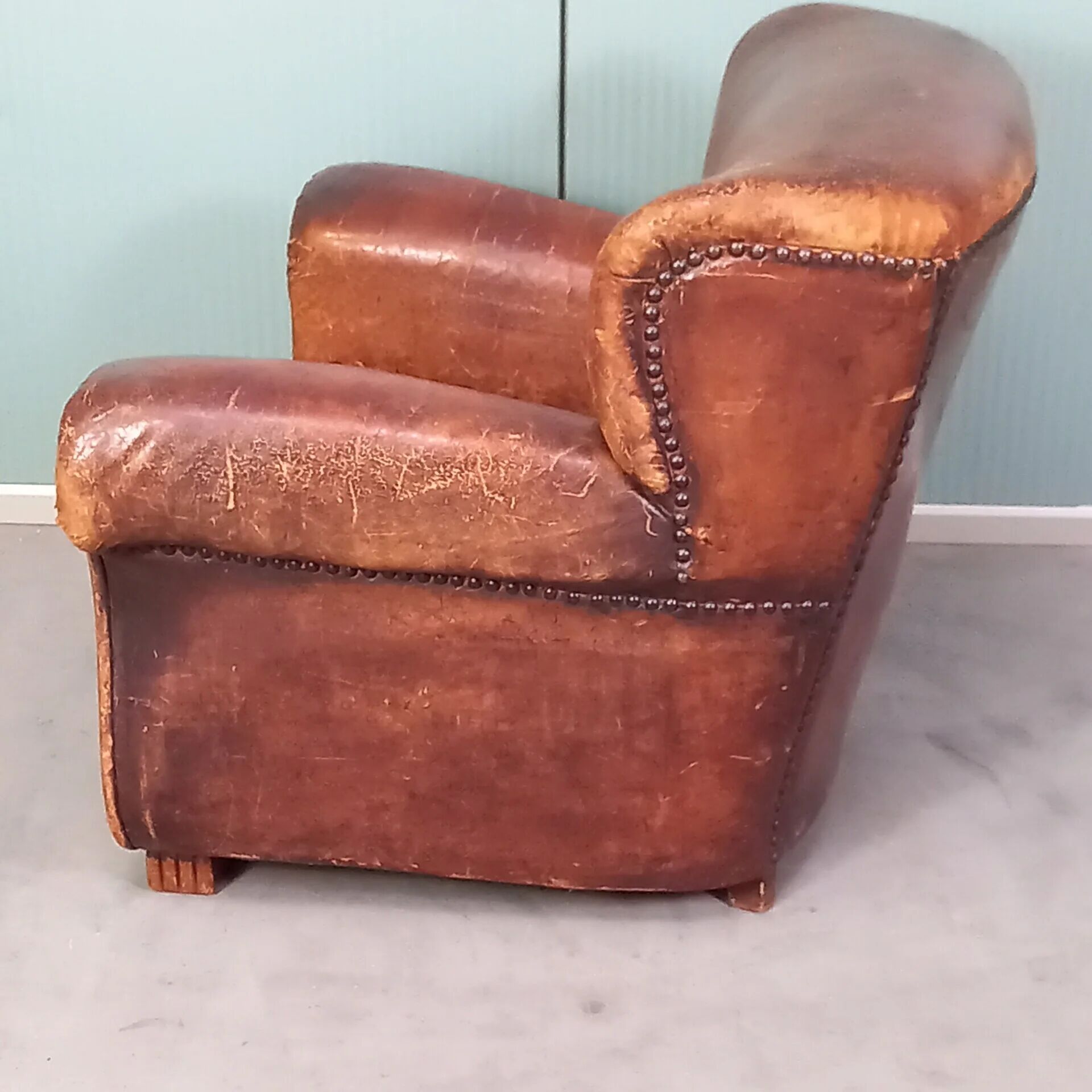 Leather nailed armchair