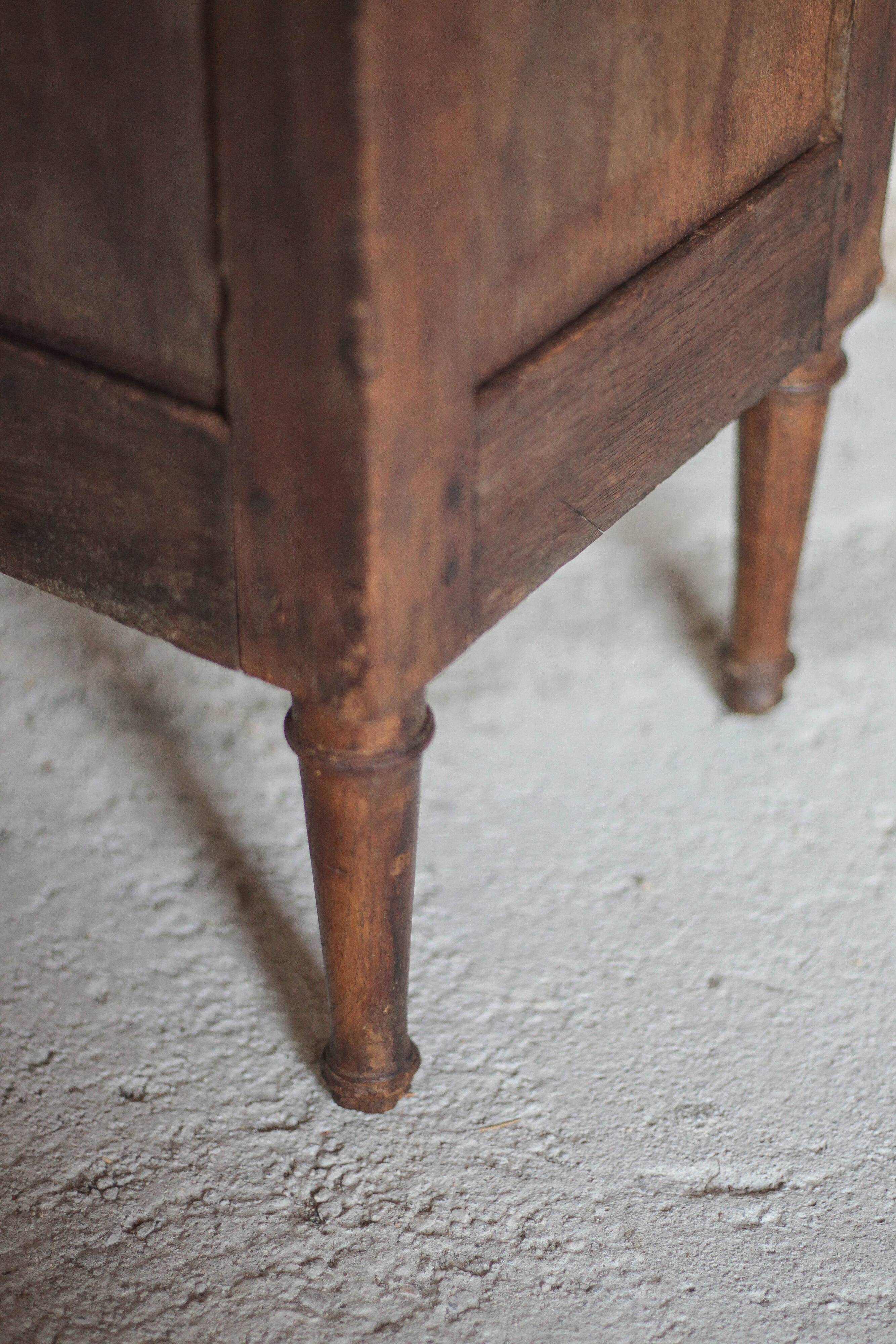 Antique wooden corner cabinet with a curved door.