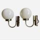 Pair of chrome metal wall lights with white glass globe.