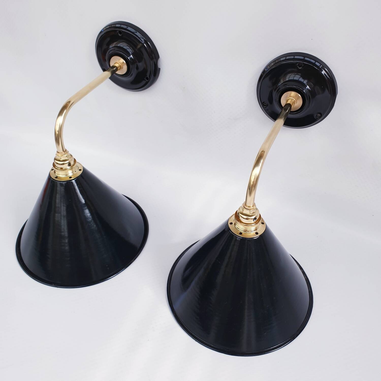 Pair of antique black enamelled sheet metal wall lights