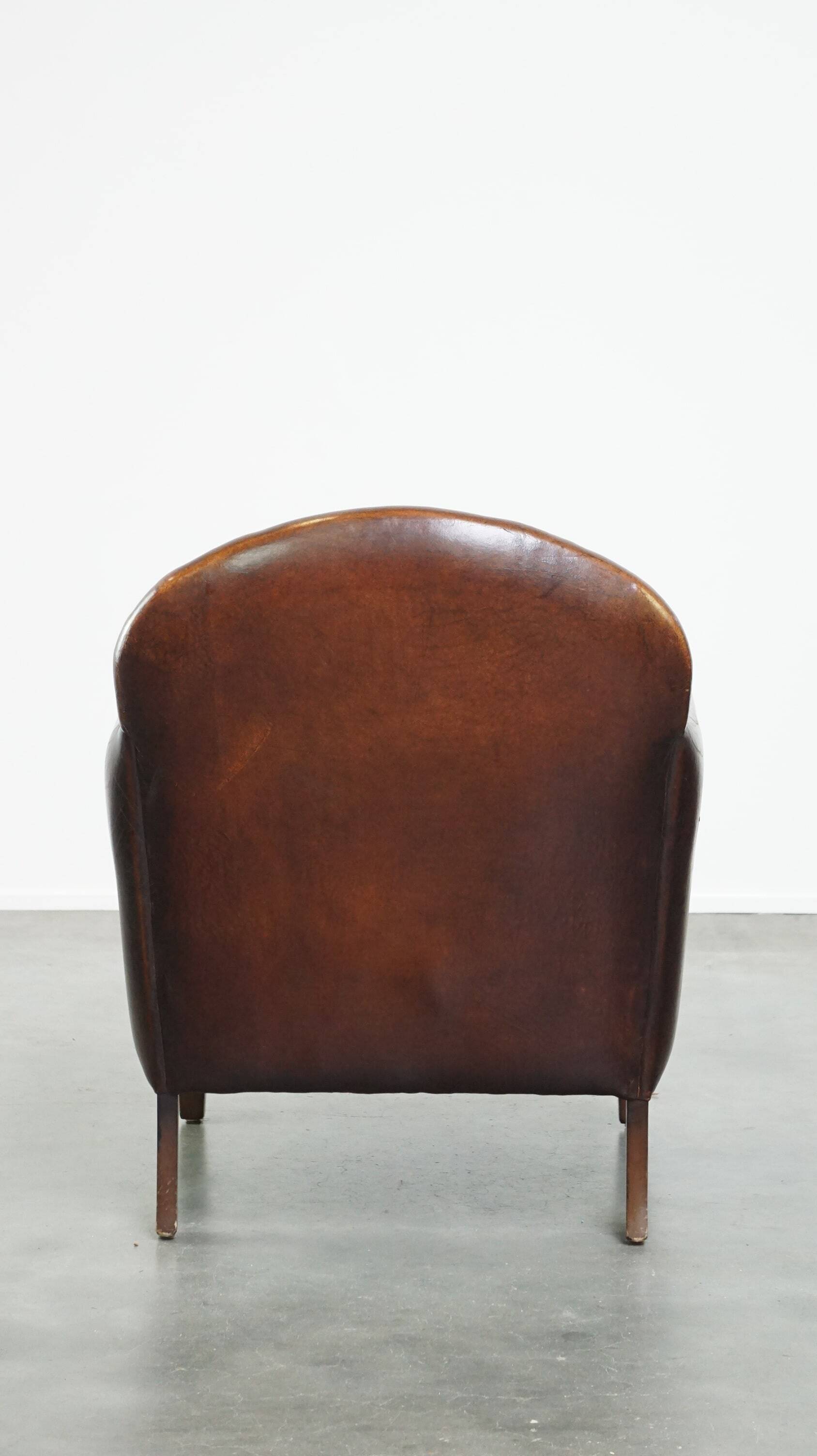 A vintage-style armchair with character, upholstered in beautifully patinated sheepskin.