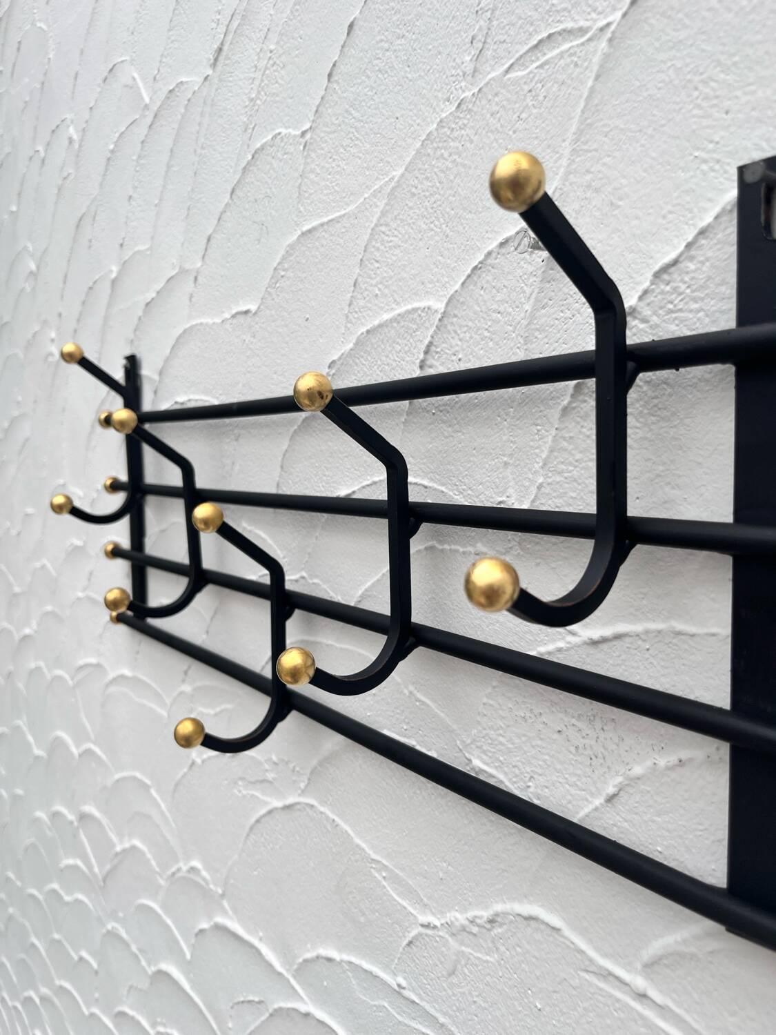 Iron and brass coat rack